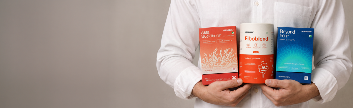 Person holding HerbSouk AstaBuckthorn, Fiboblend and Beyond Iron supplement packs.